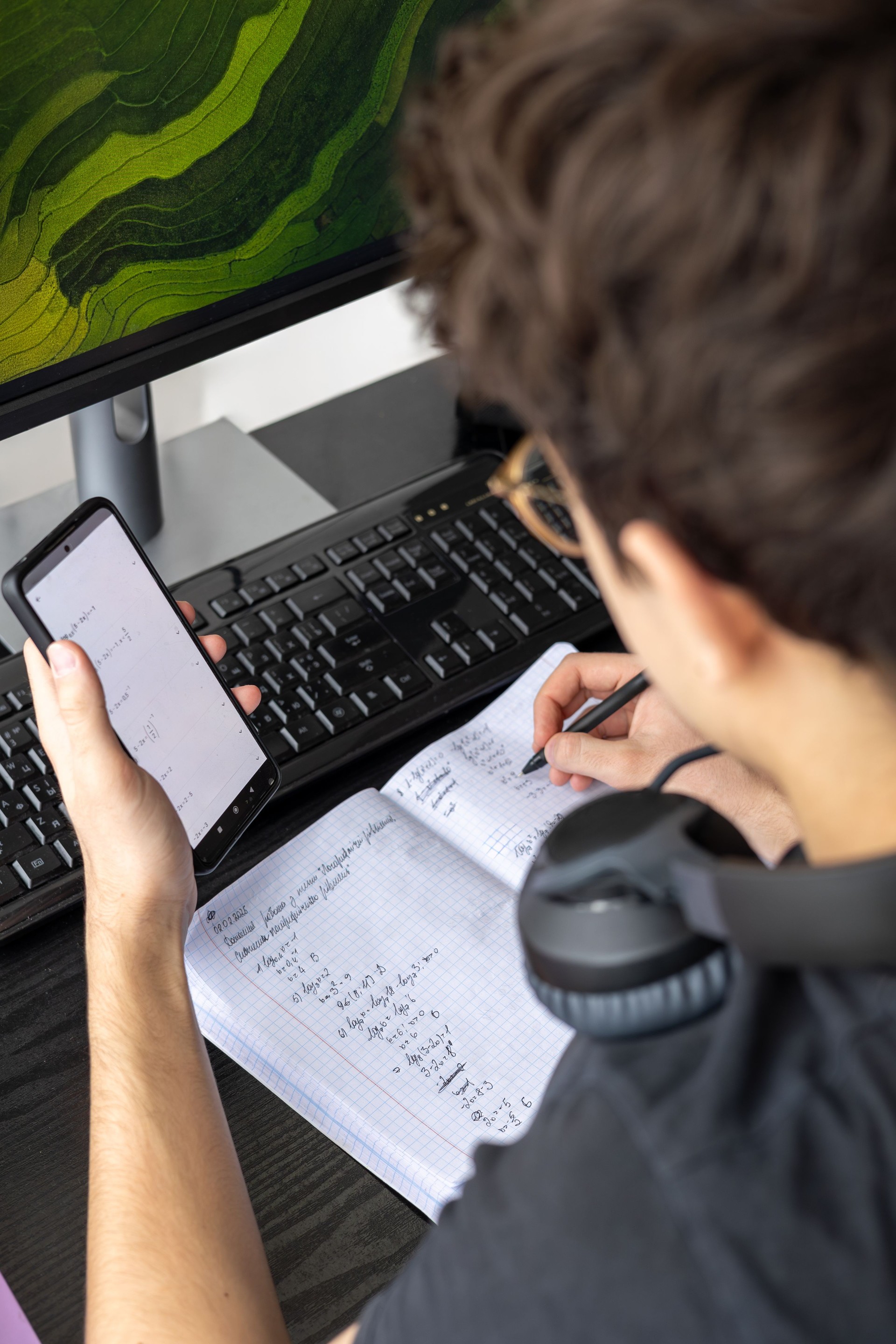 Teenager studying at home on a computer. Teen freelancer working on a project at home. Exam Preparation. Teen Boy Studying Online. cppyspace. homeschooling, inclusive education